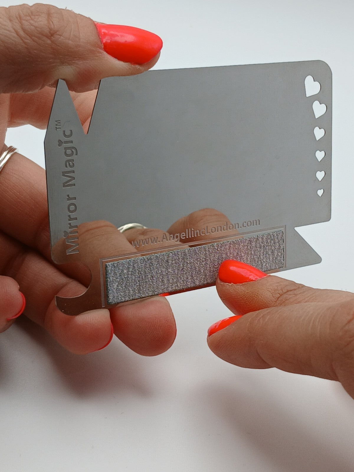 Mirror Magic nail file in hand; credit-card size scale