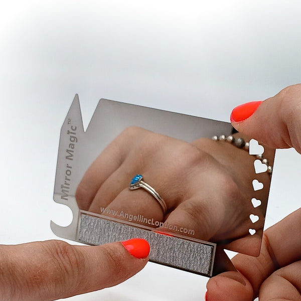 Stainless-steel nail file with mirror finish reflecting lipstick 240-grit pad shown