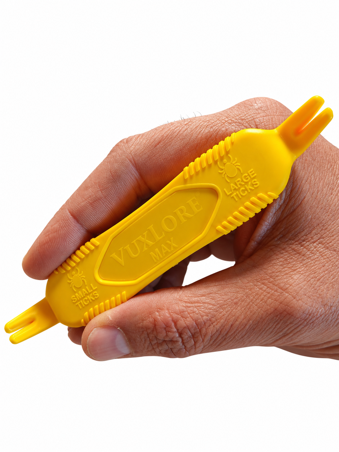 Hand holding a yellow VuxLore MAX tick remover, showing ridged grips and dual-ended forked tips labelled for small and large ticks.